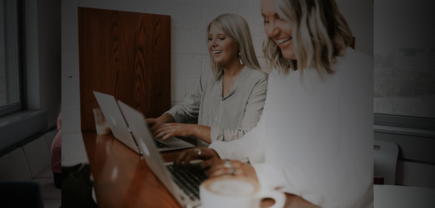 Receptionnists at reception laughing and happy