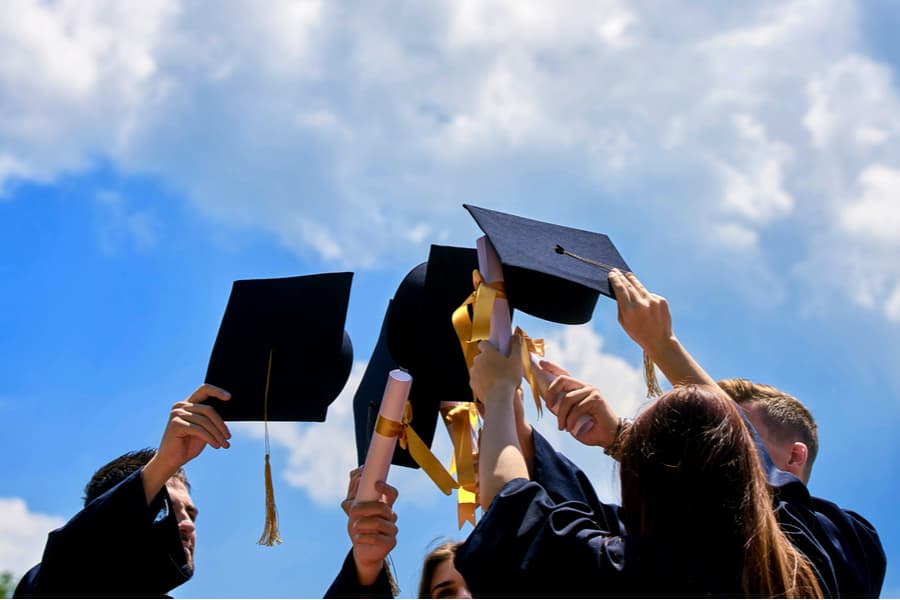 Graduates throwing their caps in the air